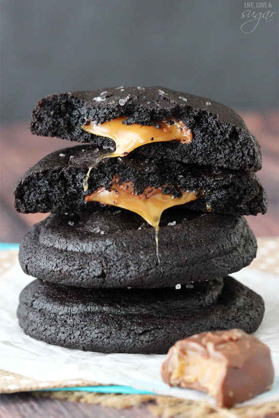 Salted Caramel Stuffed Dark Chocolate Cookies stacked with two halves on top
