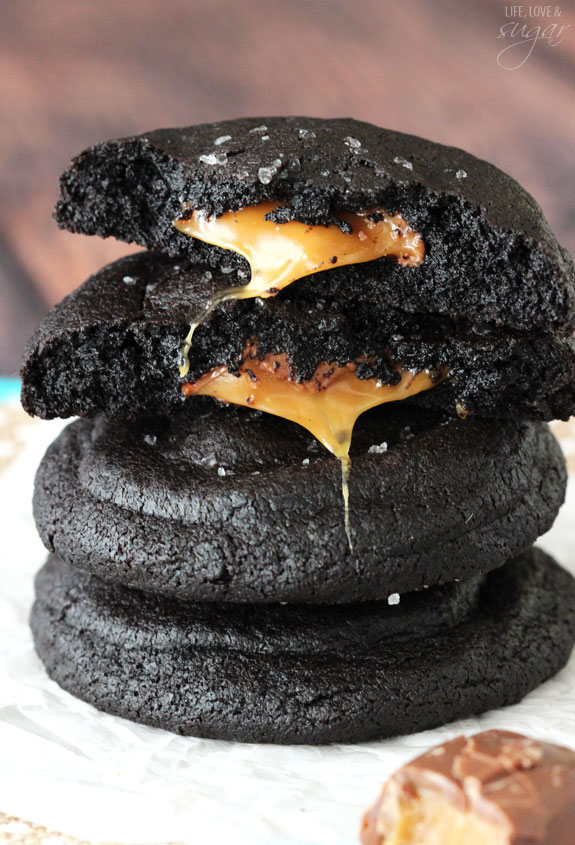 Salted Caramel Stuffed Dark Chocolate Cookies stacked with two halves on top