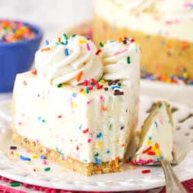 No bake funfetti cheesecake on a plate with a bite on a fork next to it