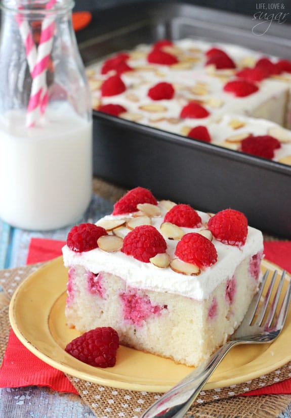 Raspberry Almond Poke Cake slice on a plate
