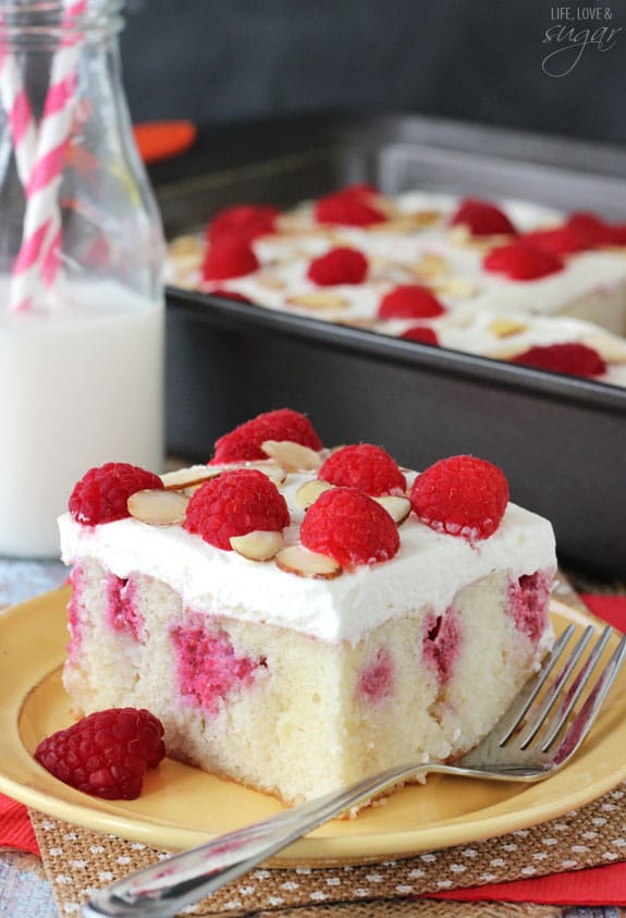 Raspberry Almond Poke Cake slice on a plate