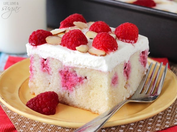 Raspberry Almond Poke Cake slice on a plate