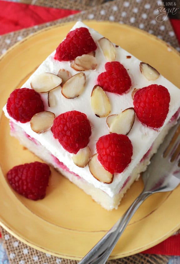 Overhead view of Raspberry Almond Poke Cake on a plate