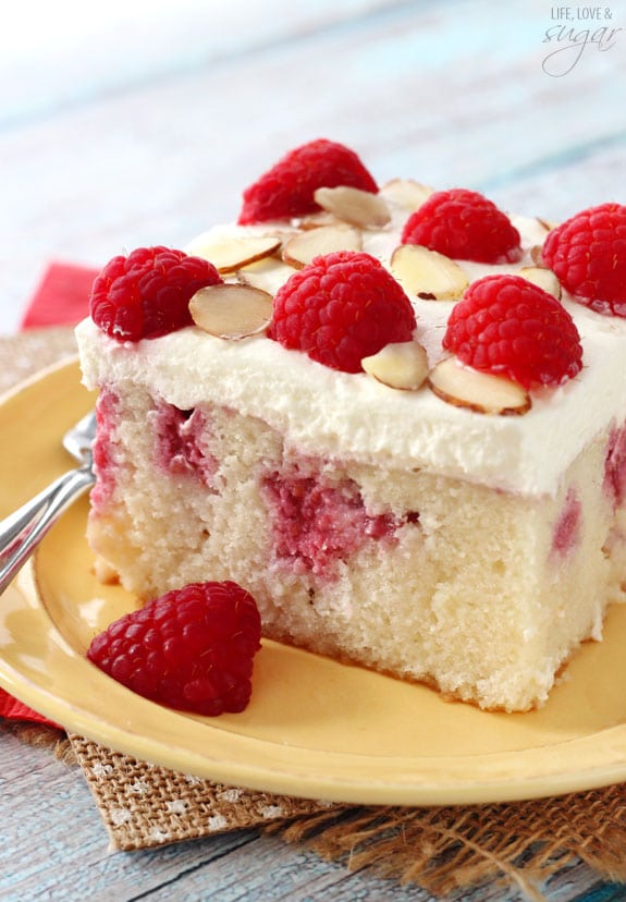 Close-up of Raspberry Almond Poke Cake slice on a plate