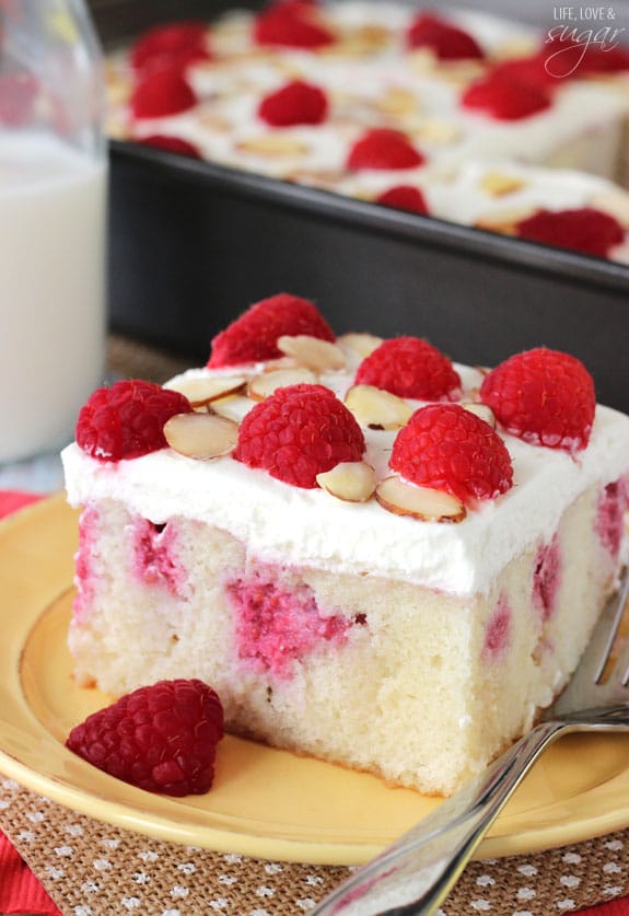 Raspberry Almond Poke Cake slice on a plate