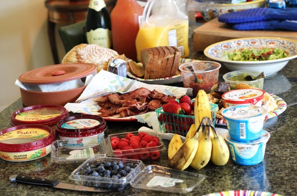 Berries, Bananas, Bread, Hummus and Other Breakfast Items on a Countertop