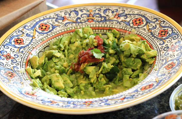 Fresh Guacamole in a Decorative Blue, Orange and Yellow Plate