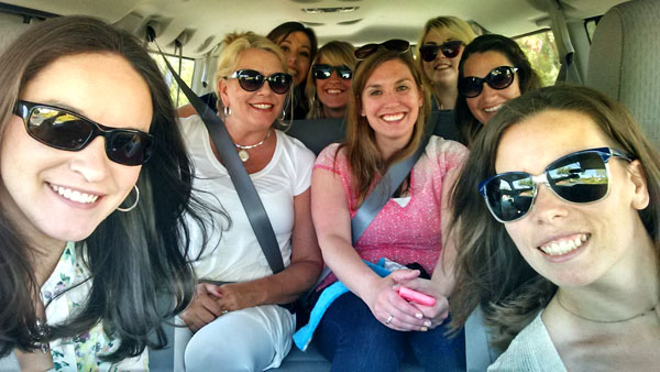 A Selfie of Eight Female Food Bloggers in a Minivan