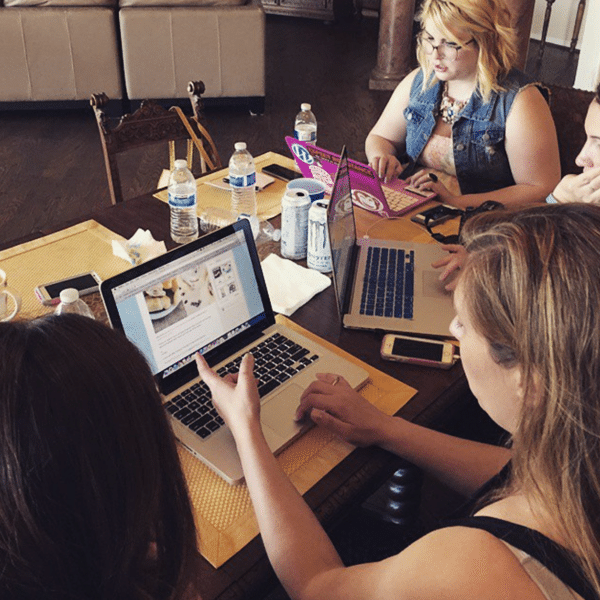 Three Women at a Dining Table Working on Their Laptops