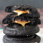 Salted Caramel Stuffed Chocolate Cookies stacked with top cookie halved