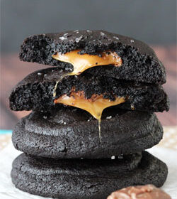 Salted Caramel Stuffed Chocolate Cookies stacked with top cookie halved