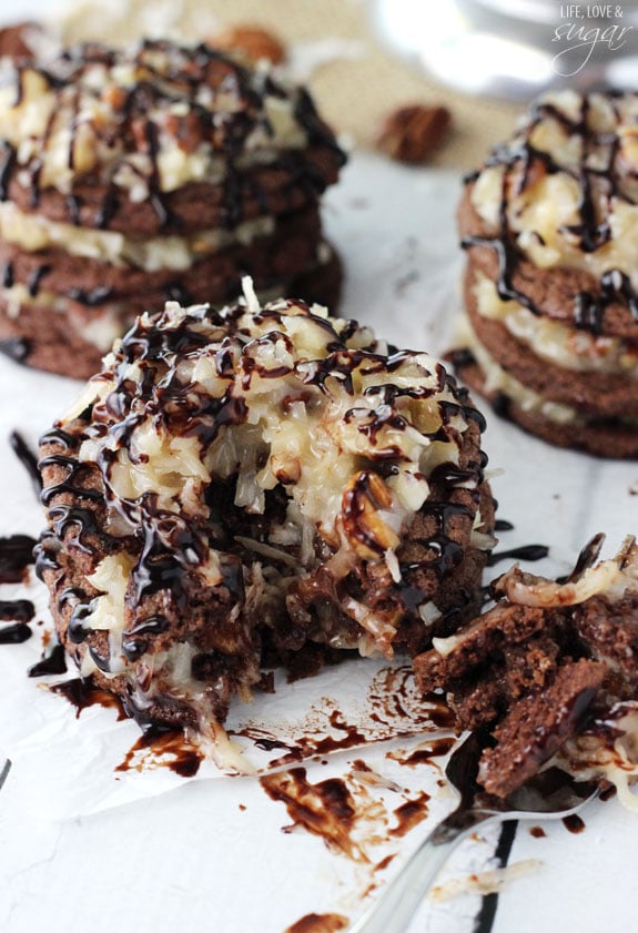 A close up of a German Chocolate Cookie Stack that has a fork removing a piece so you can see all the coconut pecan frosting layers