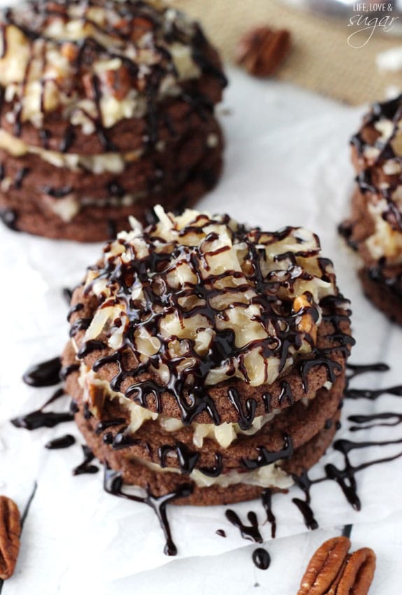 A cookie stack that has layers of German chocolate cookies and coconut pecan frosting and a chocolate drizzle