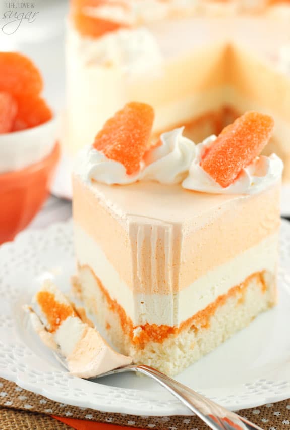 Orange Creamsicle Ice Cream Cake slice on a plate with a bite on a fork