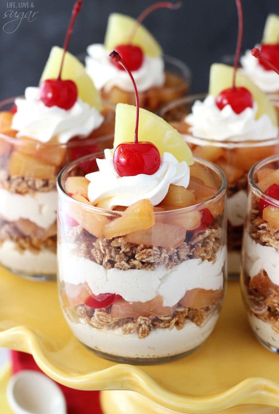 Pineapple Upside Down Trifles in glass cups on a yellow cake stand