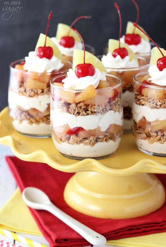 Pineapple Upside Down Trifles in glass cups on a yellow cake stand