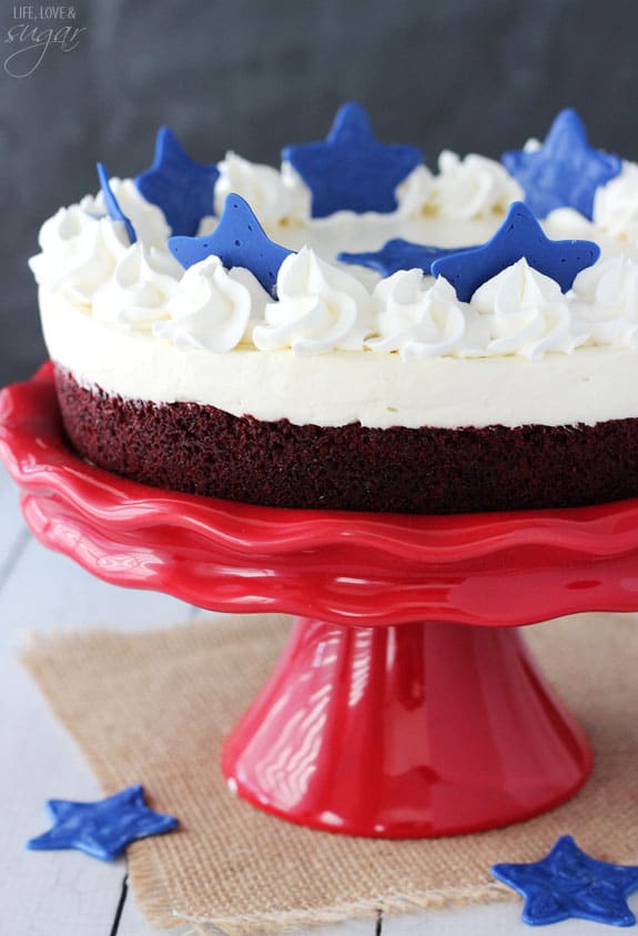 Red Velvet Blondie Cheesecake on a red cake stand topped with blue stars