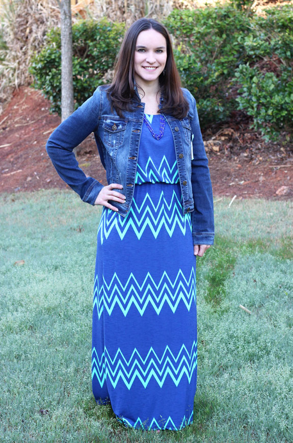 Author modeling blue dress with denim jacket