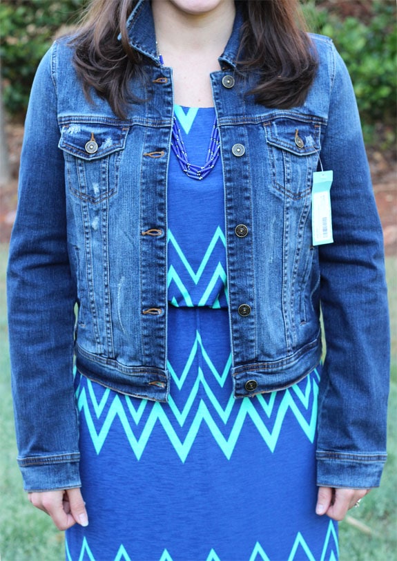 Close-up of author modeling denim jacket over a blue dress