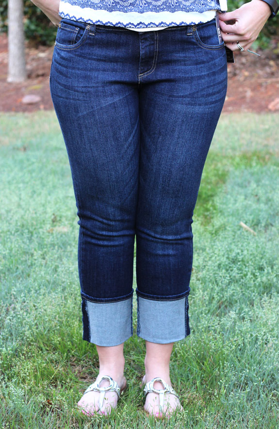 Author modeling jeans with a wide cuff at the bottom