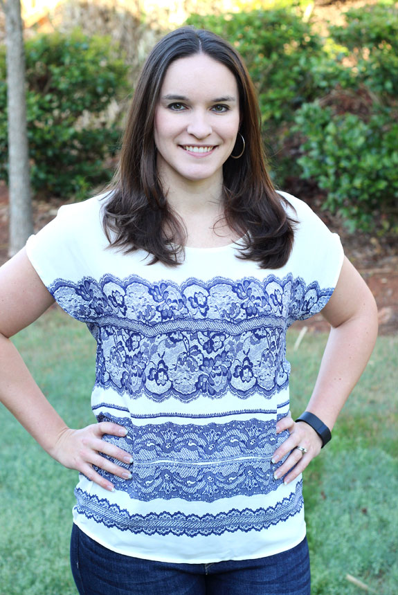 Author modeling a white shirt with blue lace