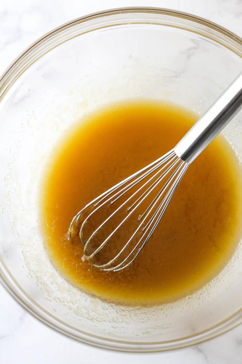 Mixing melted butter, oil, and brown sugar