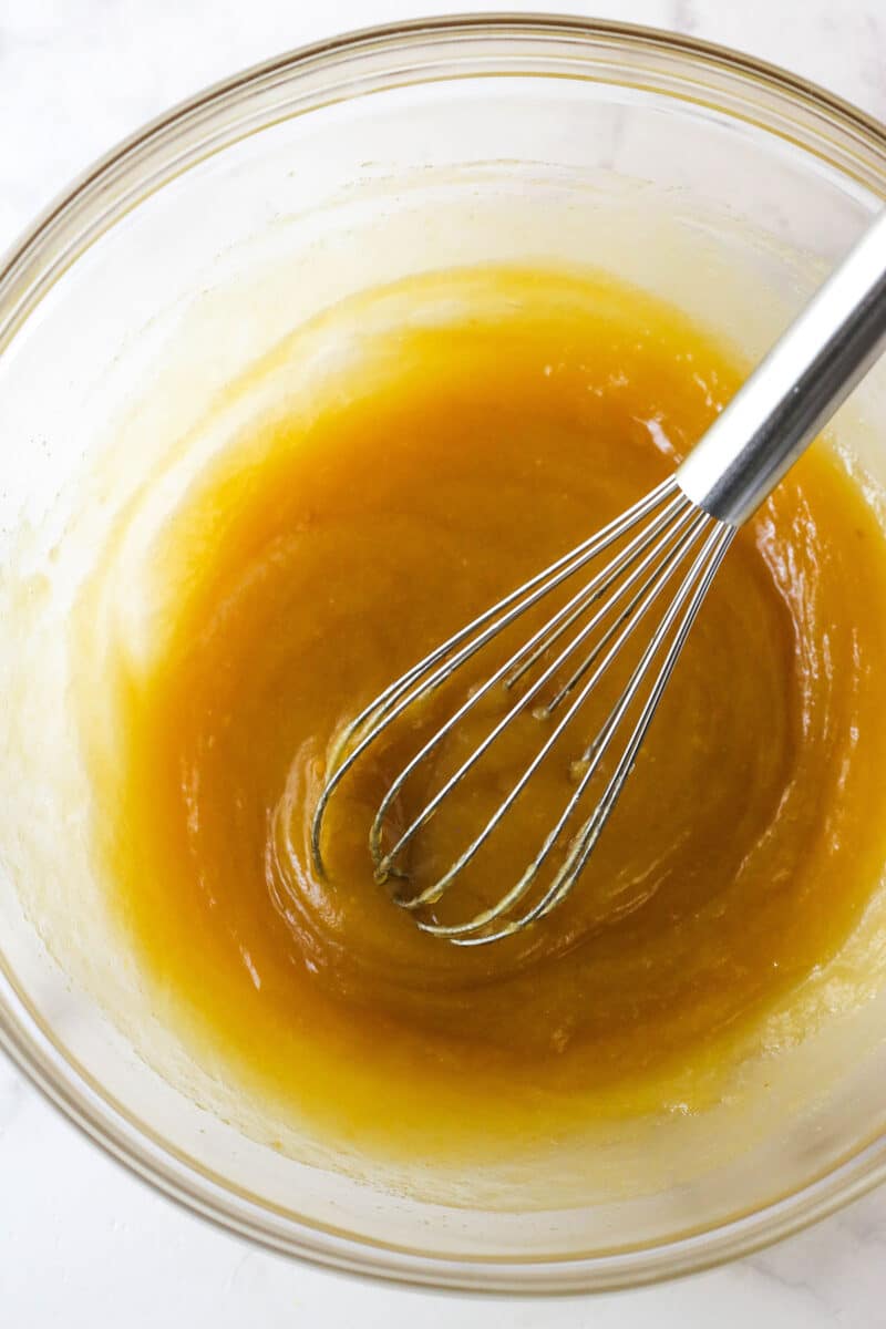 Whisking eggs, corn syrup, and vanilla into the batter mixture