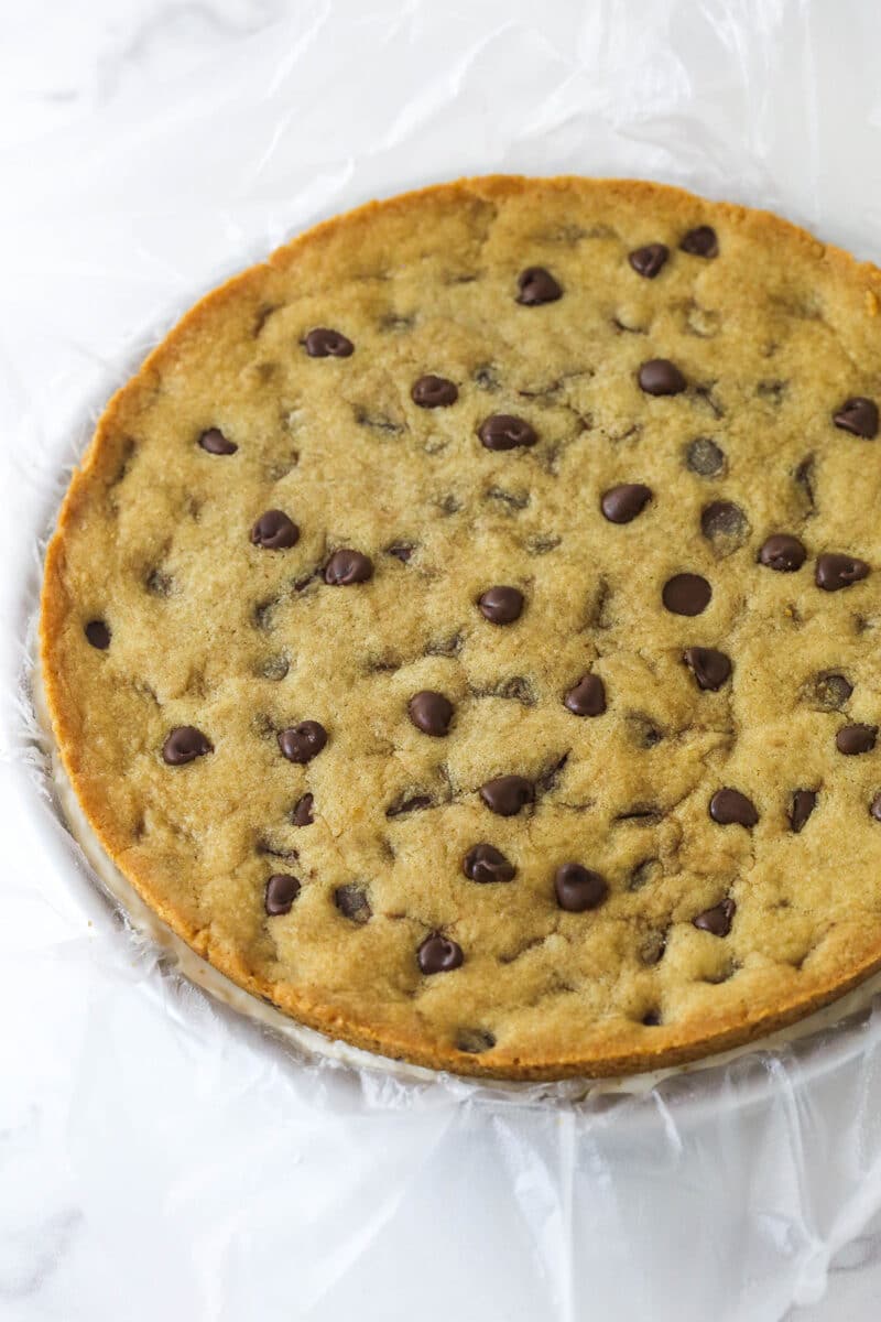 A chocolate chip cookie ice cream cake in a round pan