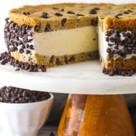 A chocolate chip cookie ice cream cake with one slice missing