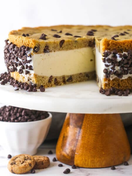 A chocolate chip cookie ice cream cake with one slice missing