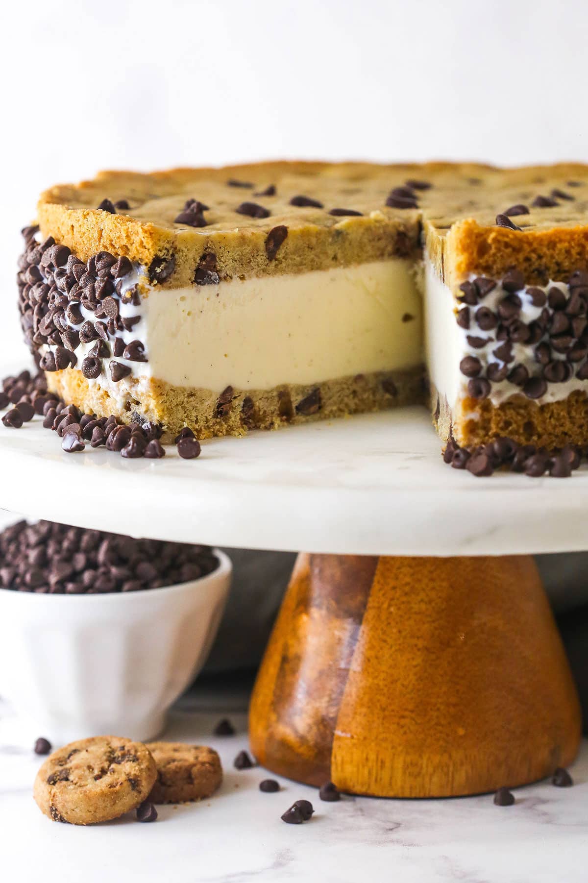 A chocolate chip cookie ice cream cake with one slice missing