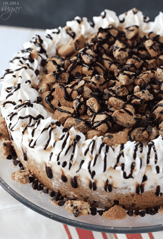 Chocolate Chip Cookie Ice Cream Cake - a layer of chocolate chip cookie with cook dough ice cream! Topped with chopped cookies, whipped cream and chocolate sauce!