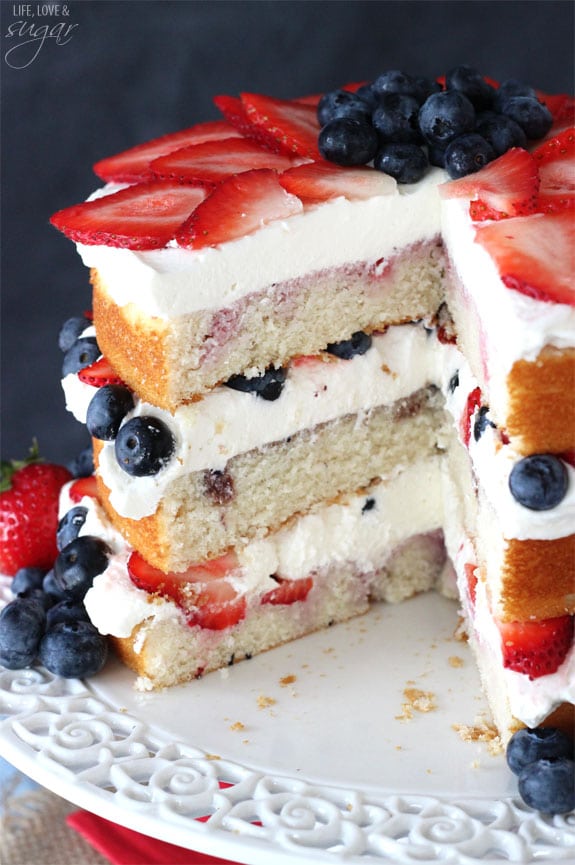 Fresh Berry Vanilla Layered Cake - layers of moist vanilla cake flavored with pureed strawberries and blueberries, layered with fresh berries and whipped cream! #pictureperfectplate