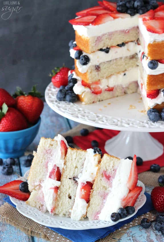 Fresh Berry Vanilla Layered Cake - layers of moist vanilla cake flavored with pureed strawberries and blueberries, layered with fresh berries and whipped cream! #pictureperfectplate