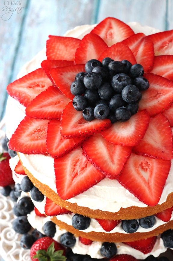 Fresh Berry Vanilla Layered Cake - layers of moist vanilla cake flavored with pureed strawberries and blueberries, layered with fresh berries and whipped cream! #pictureperfectplate