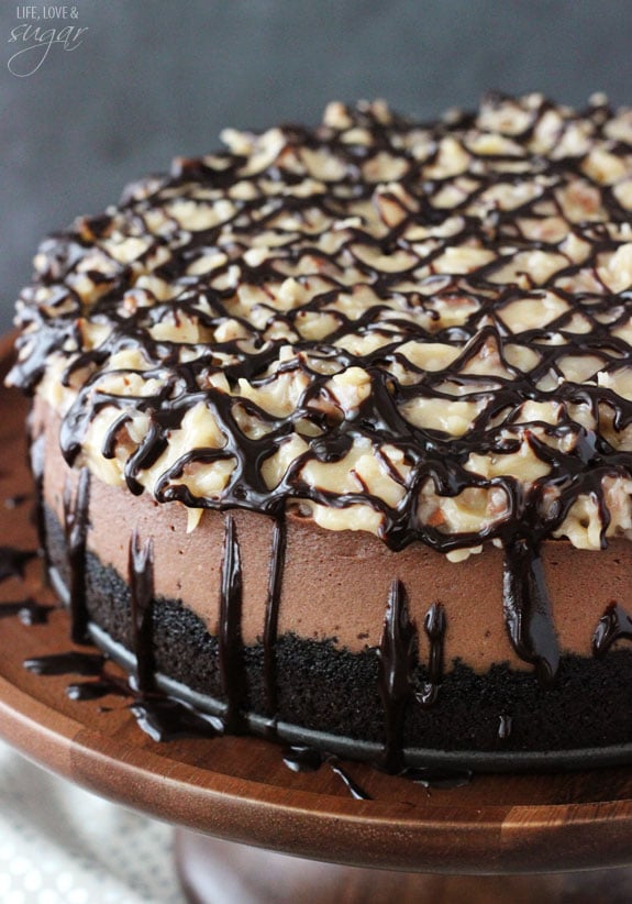 Close-up of a whole German Chocolate Cheesecake on a wooden stand