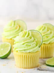 key lime coconut cupcakes on a marble backdrop