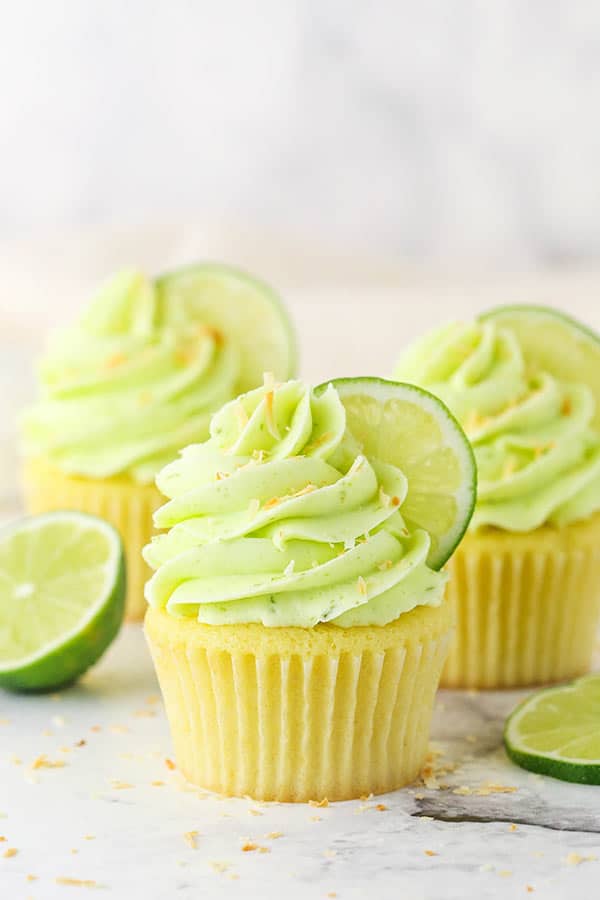 key lime coconut cupcakes on a marble backdrop