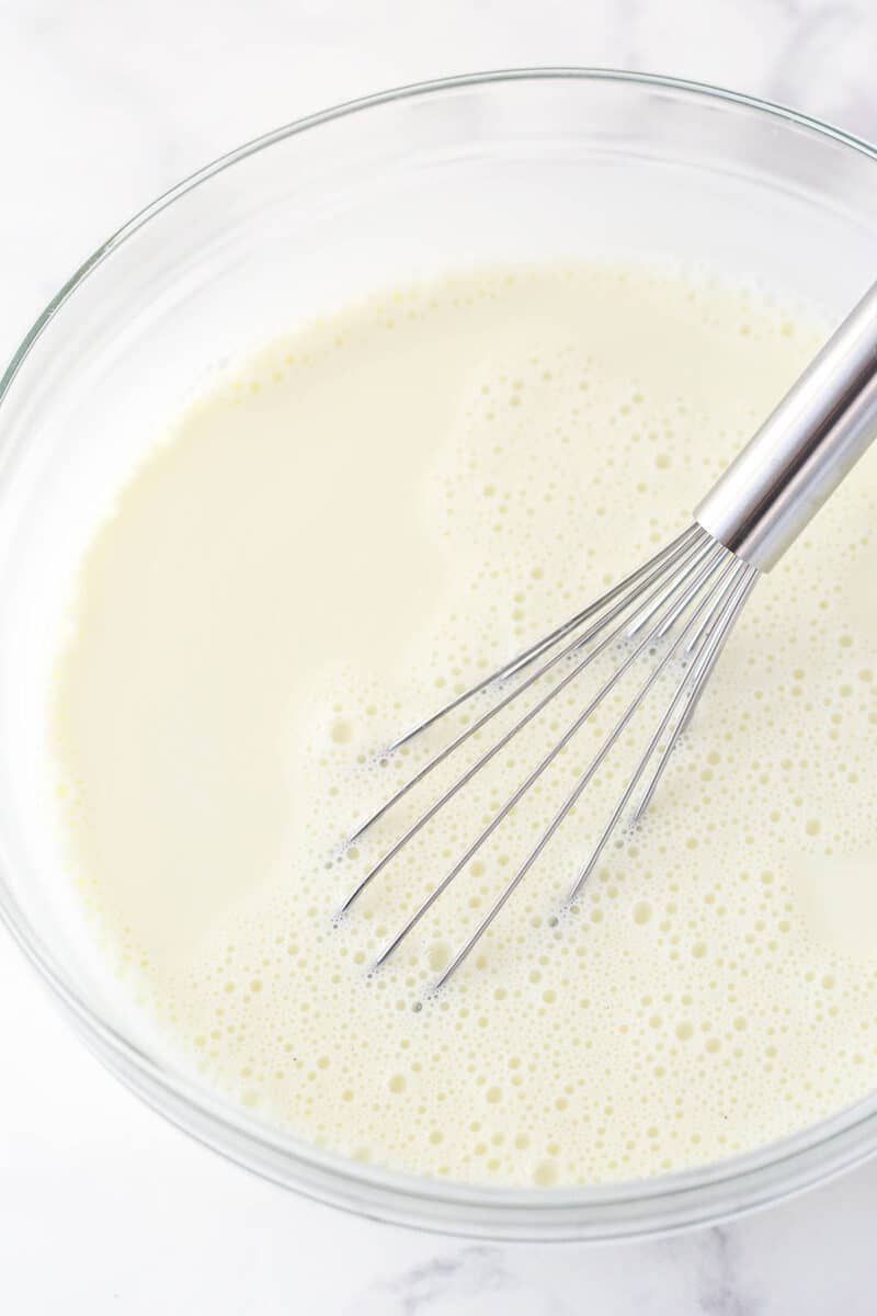 hot milk, cream, sugar and vanilla extract in large glass bowl