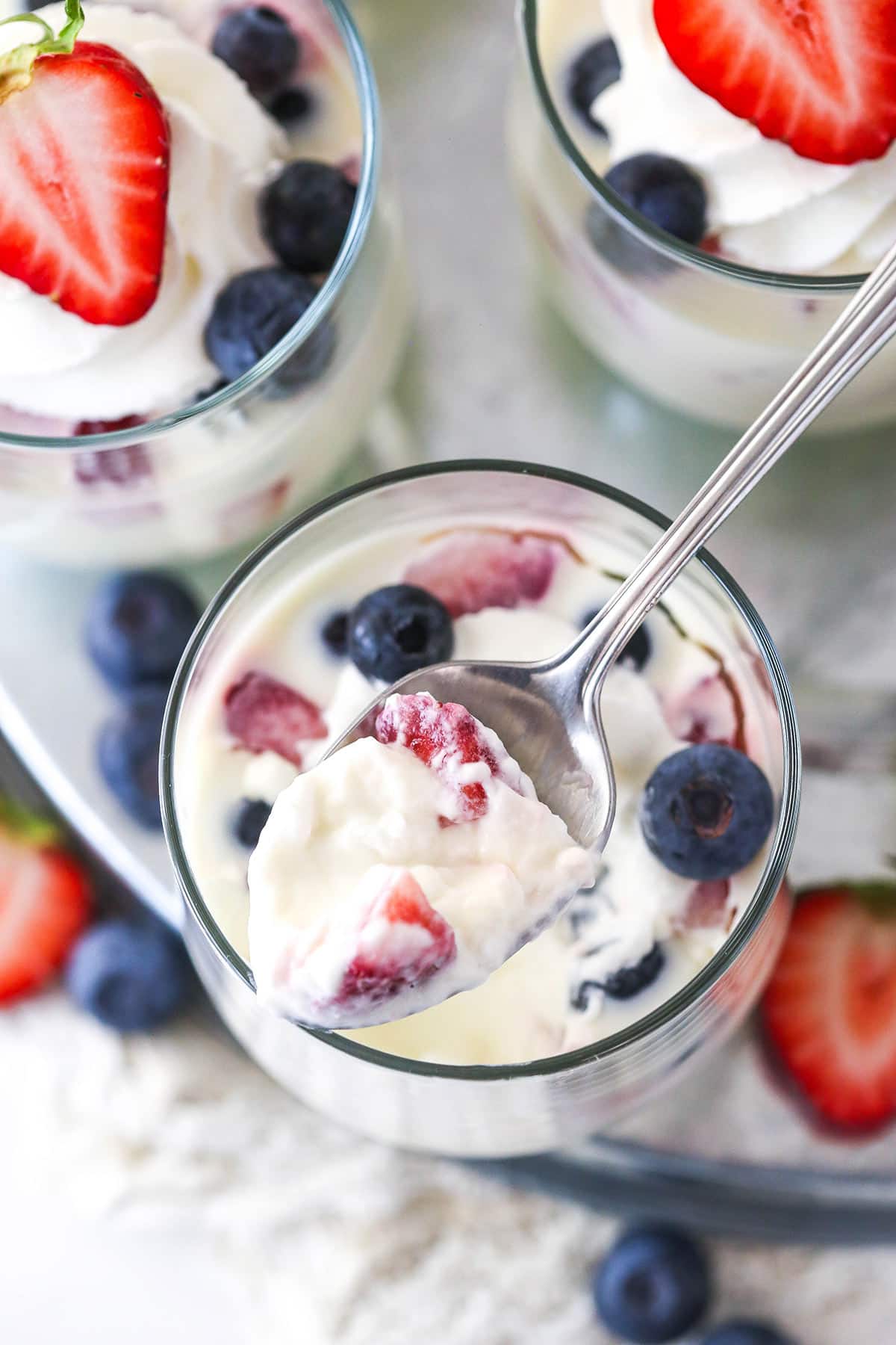 cup of panna cotta with a spoonful being lifted out