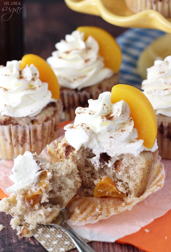 Peach Cobbler Cupcakes with a fork taking a bite from one
