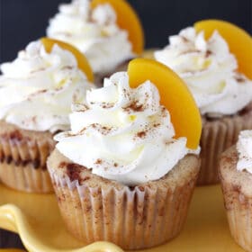 Close-up of Peach Cobbler Cupcakes on a yellow tray