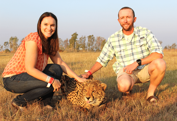 Ian and Linsday Petting a Cheetah With its Tongue Sticking Out