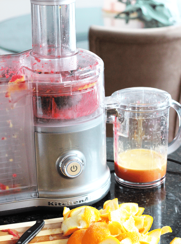 A juicer with ingredients for Raspberry Orange Shortbread Bars