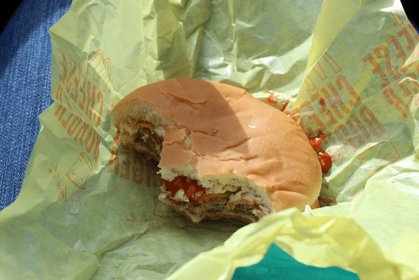 Partially-eaten McDonalds burger in a wrapper