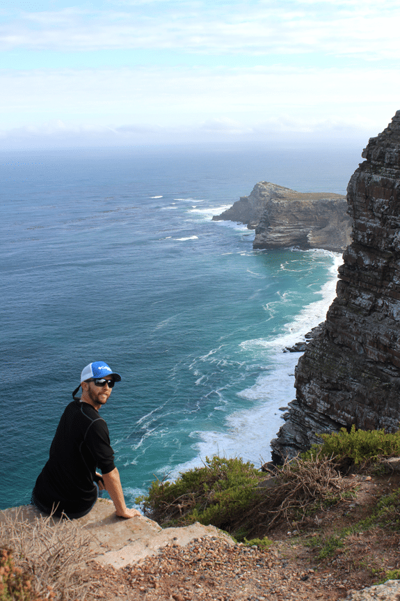 Ian at the point with water and beach below