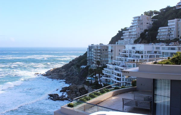 Buildings on the cliffside by the ocean