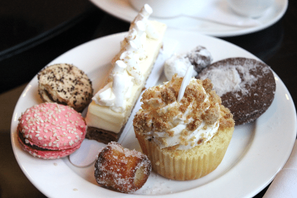 A variety of tea desserts on a white plate