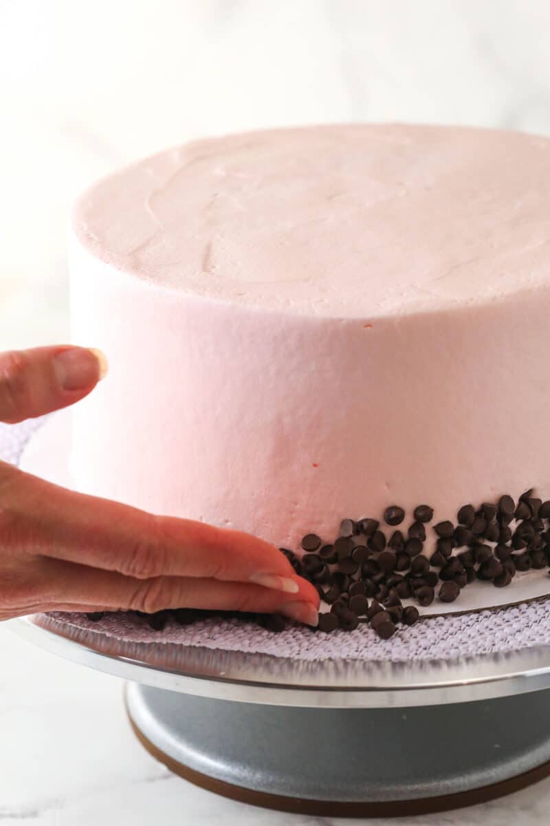 This cherry chocolate chip cake is moist, tender, and full of cherry and chocolate flavor in every single bite. Pressing mini chocolate chips into the outside of a frosted cake