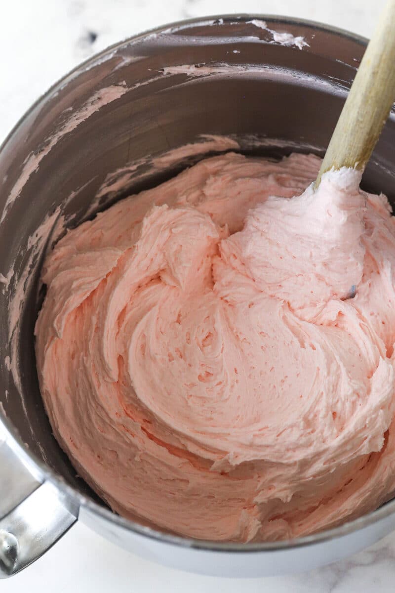 This cherry chocolate chip cake is moist, tender, and full of cherry and chocolate flavor in every single bite. Cherry buttercream in a mixing bowl